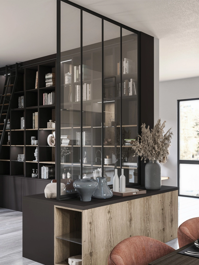 Créez une séparation subtile entre les pièces grâce à cette verrière atelier moderne associée à une grande bibliothèque modulable et un meuble bas en bois naturel. Cette réalisation sur-mesure maximise la lumière et le rangement tout en structurant les espaces de vie de façon chaleureuse et élégante.